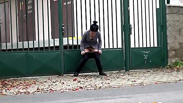 Tattooed girl pees in a driveway in public