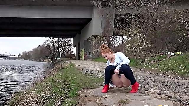 Redhead by the river takes a hot piss