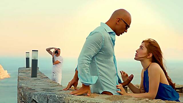 A couple enjoys passionate sex under the open sky with a stunning redhead.