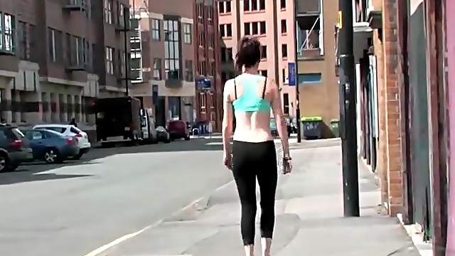 Sporty babe walks the streets in her workout clothes