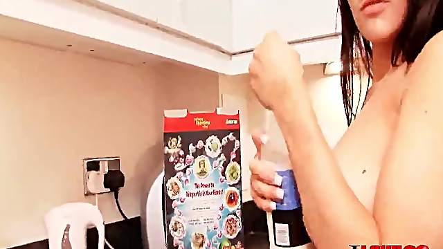 Topless girl pours cereal and milk on her tits