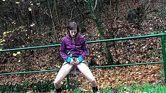 Teen lifts her skirt to pee in the grass