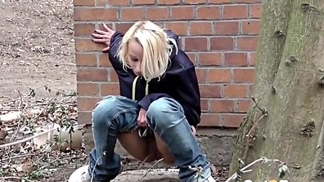 Teen lowers her jeans and pees outdoors