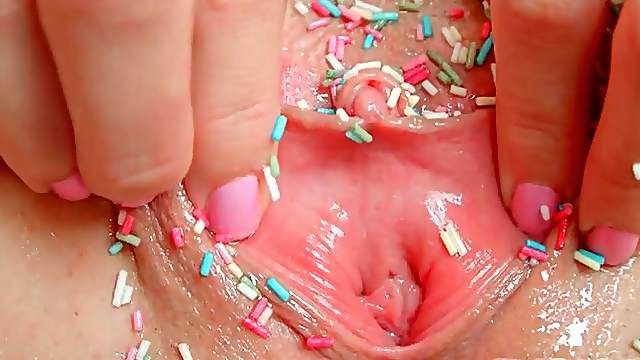 Masturbating girl drops sweet sprinkles on her pussy